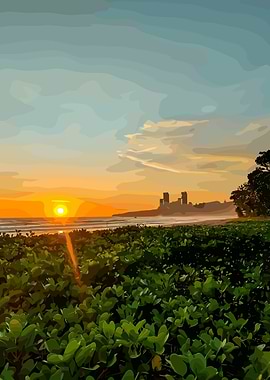 Sunset over a beach with lush greenery