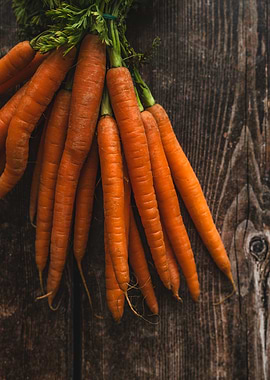 Bunch of fresh carrots on wood