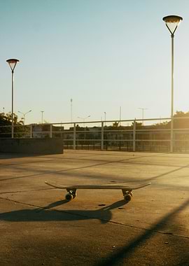 Skateboard on concrete at sunset