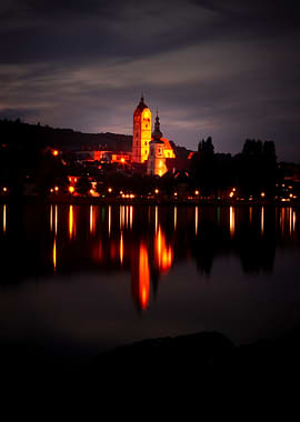 Cityscape at Night with Lake Reflection