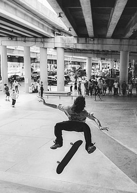 Skateboarder mid-air trick under overpass