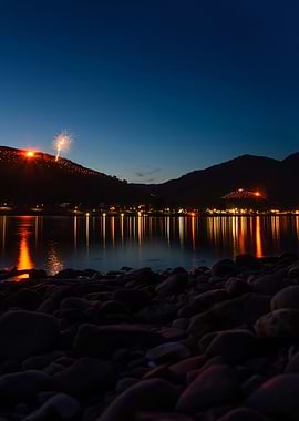 Fireworks over a river at dusk