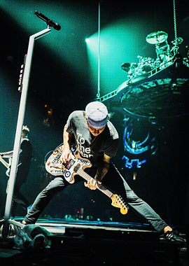 Musician playing guitar on stage
