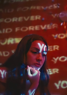 Woman with 'YO' and 'FOREVER' projected on her