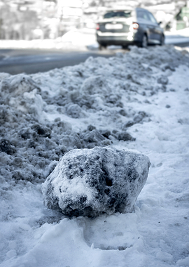 Snowy roadside with a car