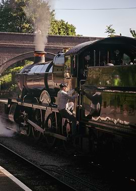 Train driver climbing onto steam engine