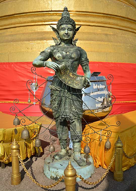 Bronze Statue with Bells and Golden Background