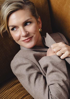 Woman in a beige jacket on a couch