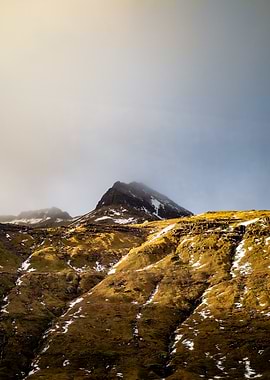 Misty Mountain Peak with Golden Slopes