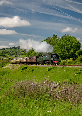 Steam Train Traveling Through Green Countryside