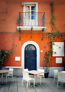 Outdoor Cafe Seating with Orange Building