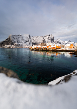 Snowy Norwegian Village by the Water