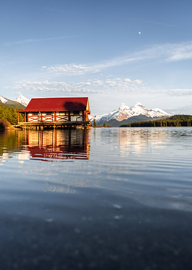 Boathouse on a serene lake with mountains