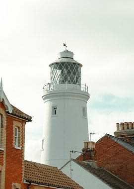 White Lighthouse with Coastal Buildings