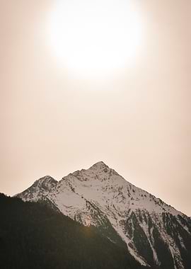 Snow-capped mountain under a bright sky