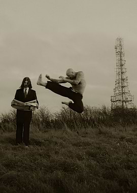 Martial Artist Kicks Near Man Reading Newspaper