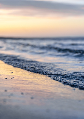 Gentle Waves on a Sandy Beach at Sunset