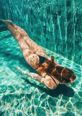 Woman swimming underwater in a pool