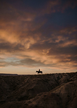 Lone Cowboy Riding at Sunset