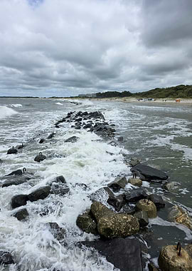 Waves Crashing Over Coastal Breakwater