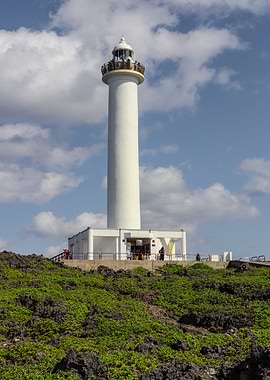 Tall White Lighthouse on Rocky Coast in Japan