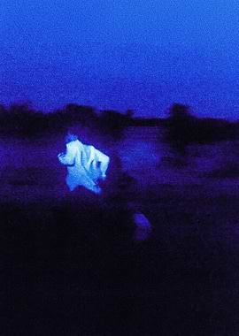Blurry Figure Running in Blue Night