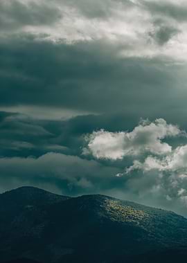 Dramatic Mountain Landscape Under Stormy Clouds