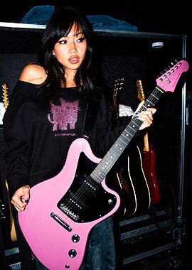 Beabadoobee Holding Pink Electric Guitar