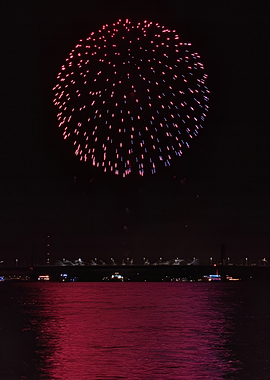 Vibrant Pink Fireworks Over Water