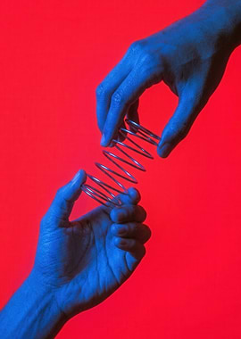 Blue Hands Holding Metal Spring