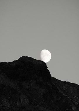 Moon Rising Over Dark Mountain Peak