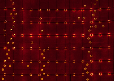 Grid of warm white lights reflecting from a red steel w ...