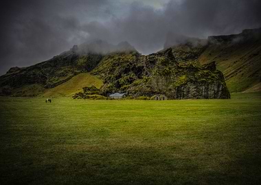 A field near Skógafoss. The buildings are actually bui ...