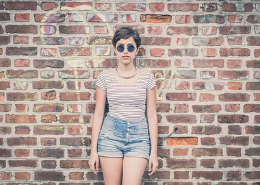 Young hipster girl and wall