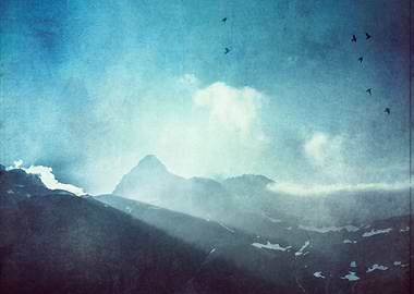 light beams over a mountain ridge in the Swiss alps.