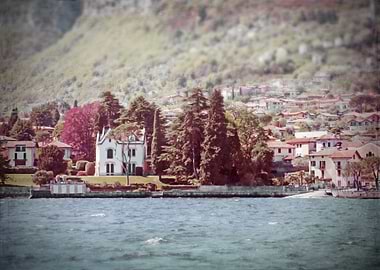 On Lake Como, a white Italian villa and a lakeside and ...