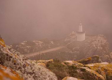 Curious light. Lighthouse at the end of a rocky path. C ...