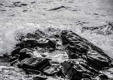 A rock pool at the edge of the Mediterranean Sea on a s ...