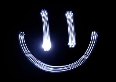 Photograph of a happy face drawing made with long expos ...