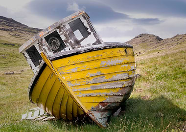 An old, ruined boat stuck on the land in Hofn, Iceland