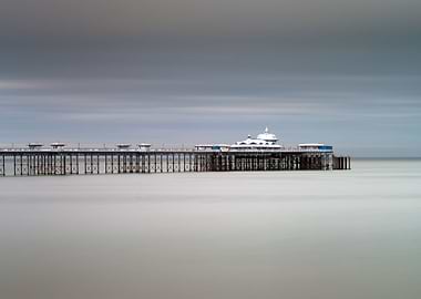 Calm sea around the Victorian Llandudno pier in North W ...
