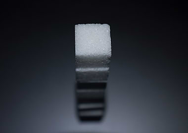 A classy macro photograph of a stack of sugar cubes. Li ...