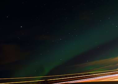 The aurora over top of a highway, got some taillights t ...