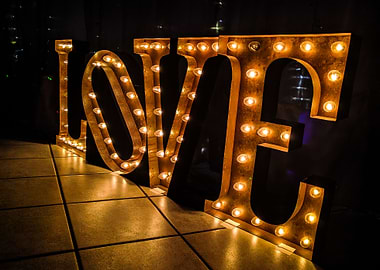 Industrial letters spell the word 'love' with glowing e ...