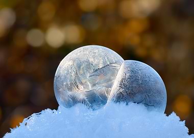 A close-up of a fragile frozen soap bubble with ice cry ...