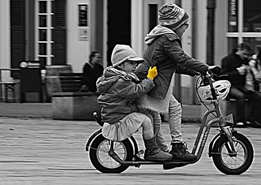 Two youngsters having fun on a scooter