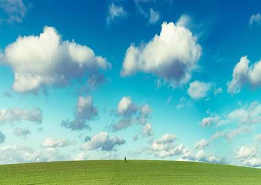 infinity - tiny person on a meadow under a bright cloud ...