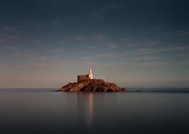 A calm full tide evening at Mumbles Lighthouse in Swans ...