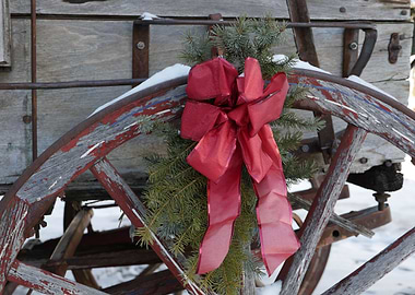 Red Bow Wreath on Vintage Wooden Wheel Trailer