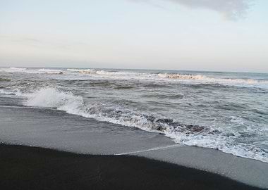 sea waves in a black sand